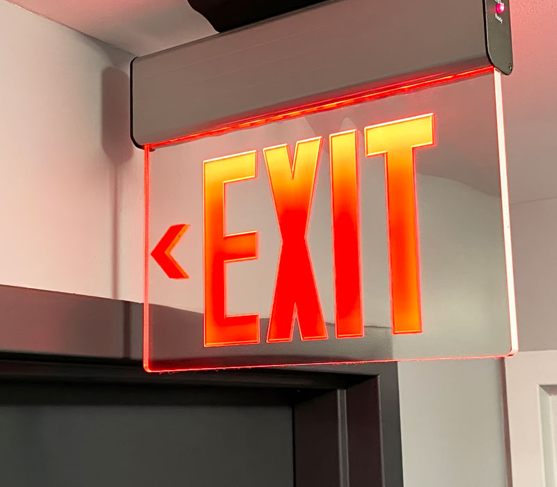 illuminated exit sign next to door